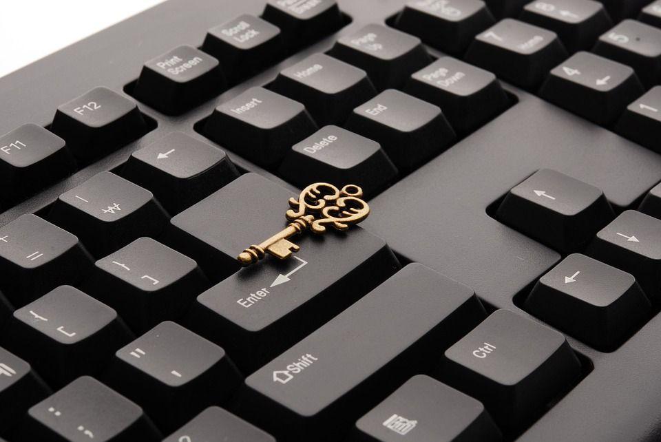 ornate key sitting on top of black keyboard | thunderbolt digital