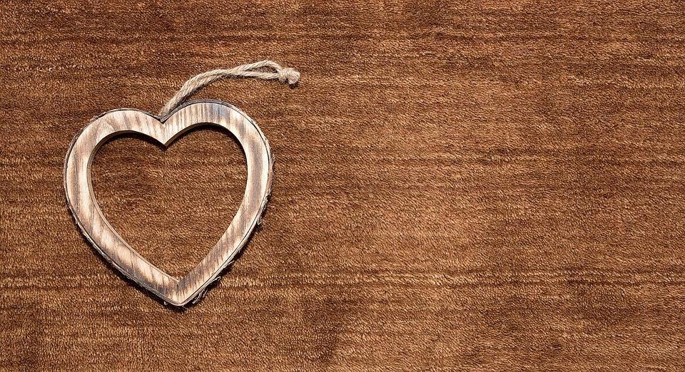 A wooden heart on a brown backdrop |Graphic Design Surrey | Thunderbolt Digital