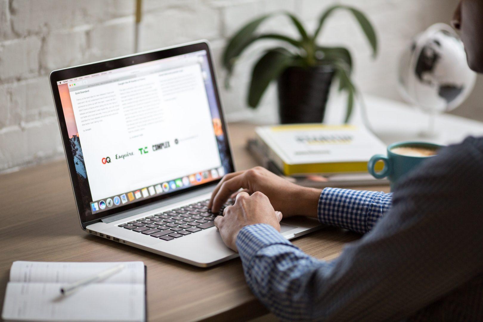 man looking at laptop, marketing agency surrey