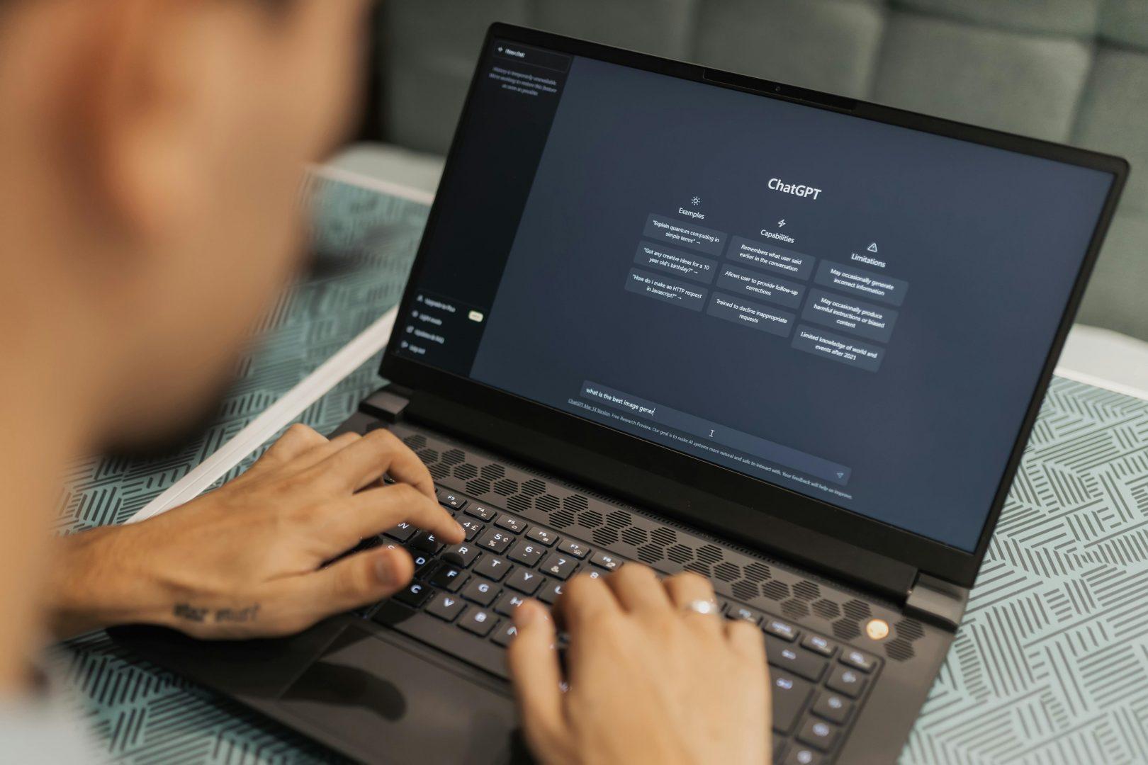 A man viewing ChatGPT on his laptop screen, about to use it for online marketing in Surrey