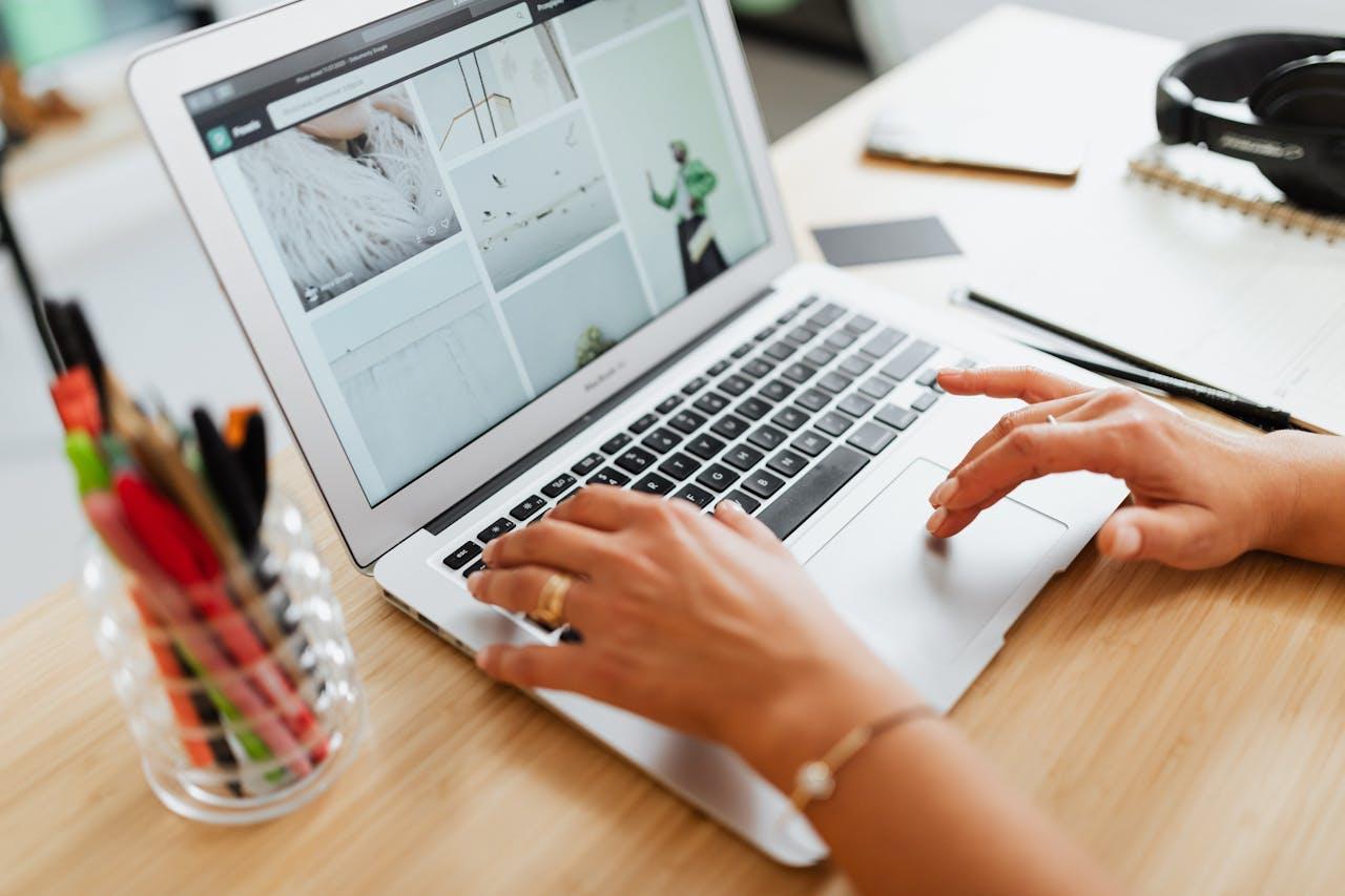 A person searching images on a laptop | Online Marketing in Guildford