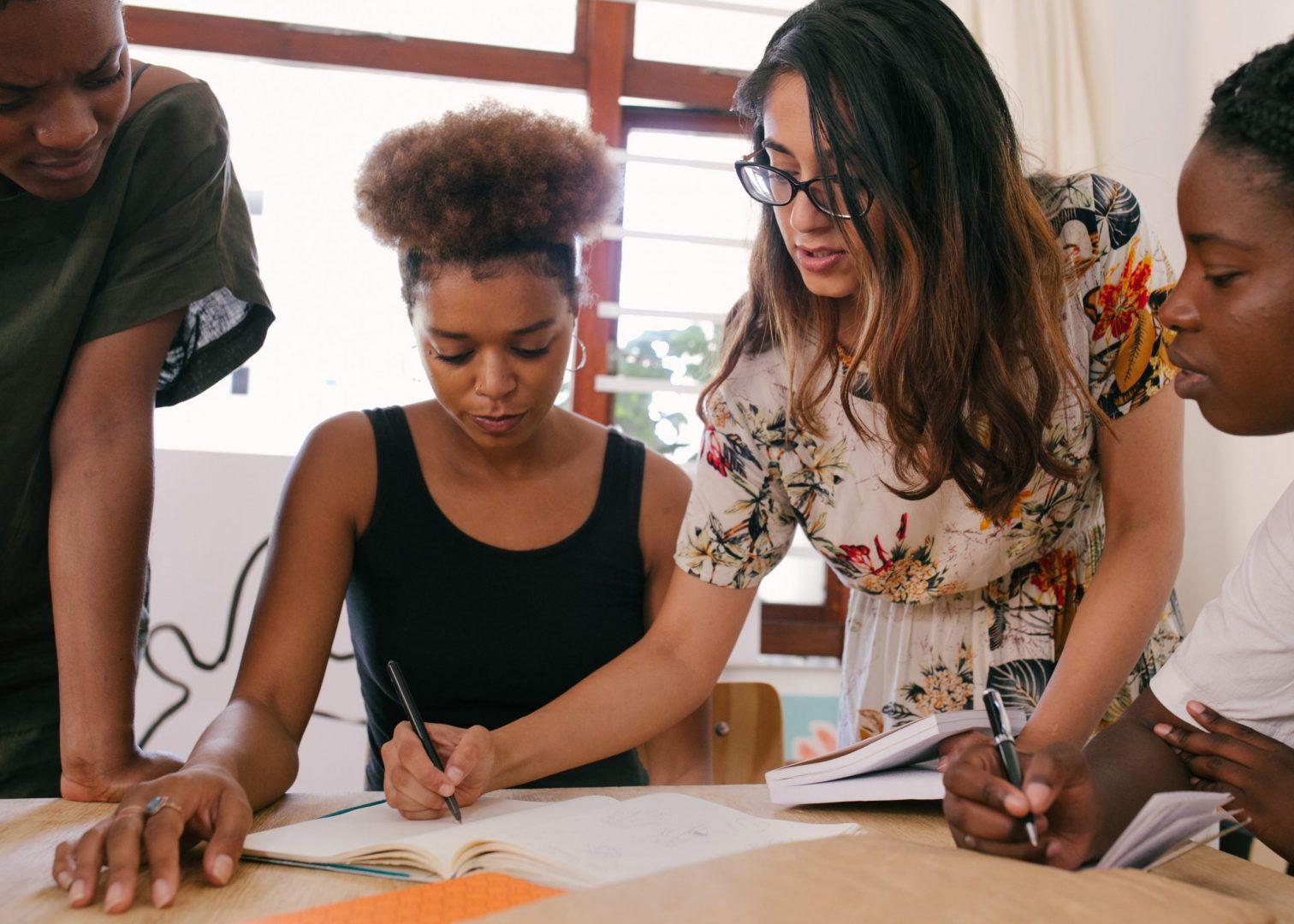 A team brainstorming around a notebook
