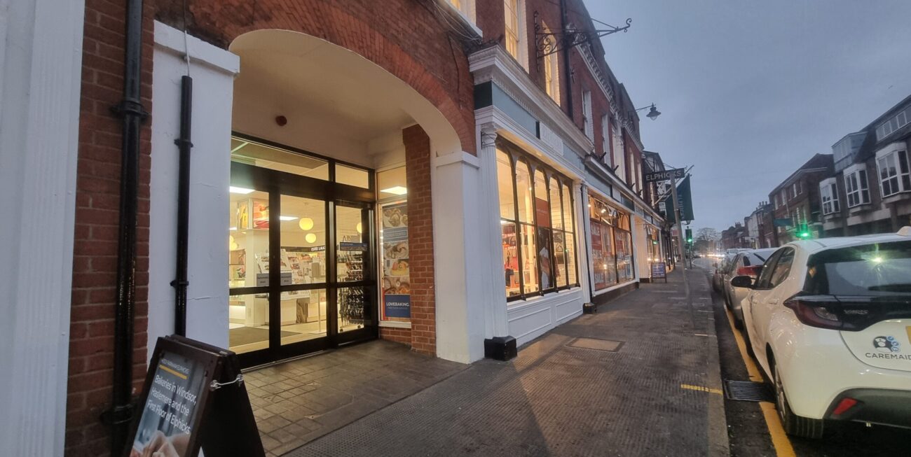 Person using laptop whose business is invisible online, with coffee nearby.