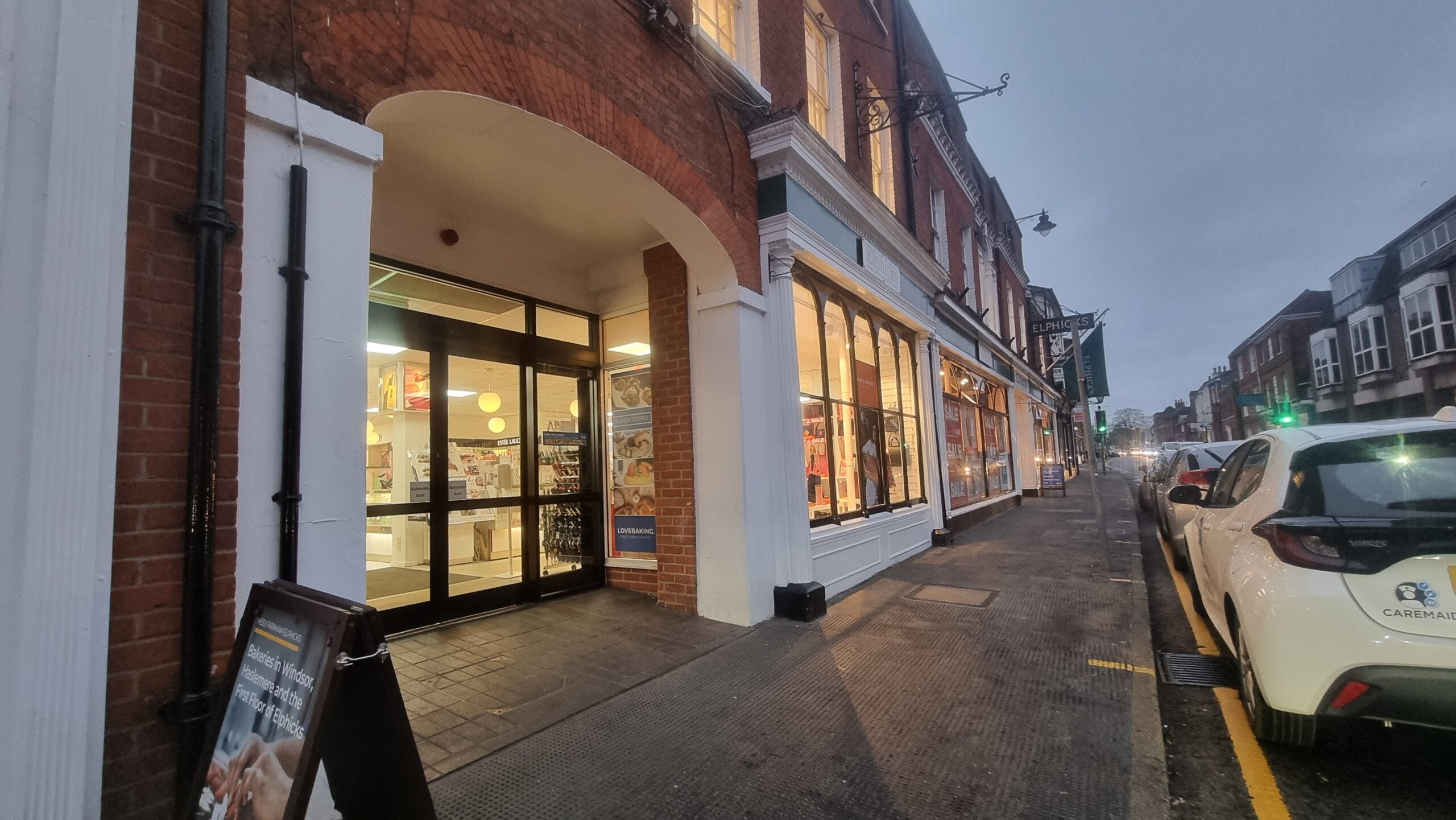 Person using laptop whose business is invisible online, with coffee nearby.