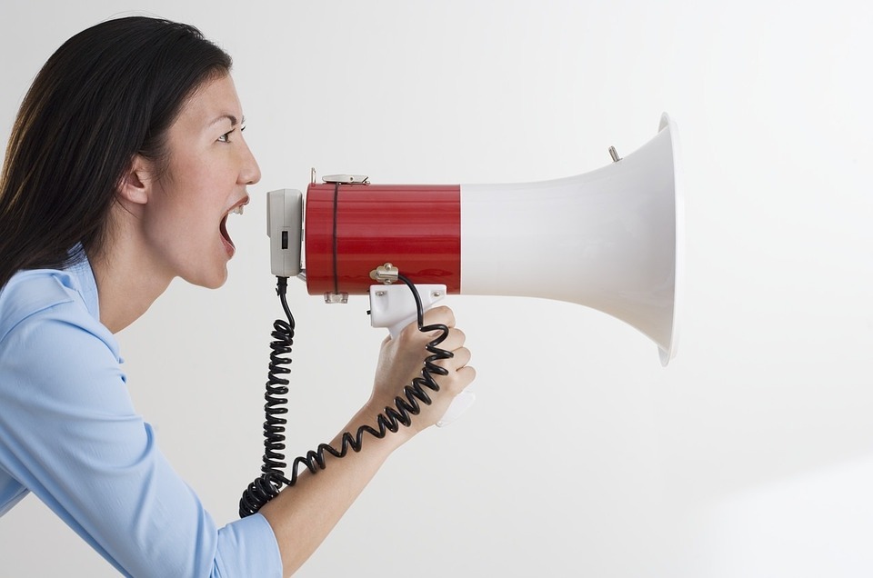 Woman shouting into a megaphone | Social Media Marketing in Surrey | Thunderbolt