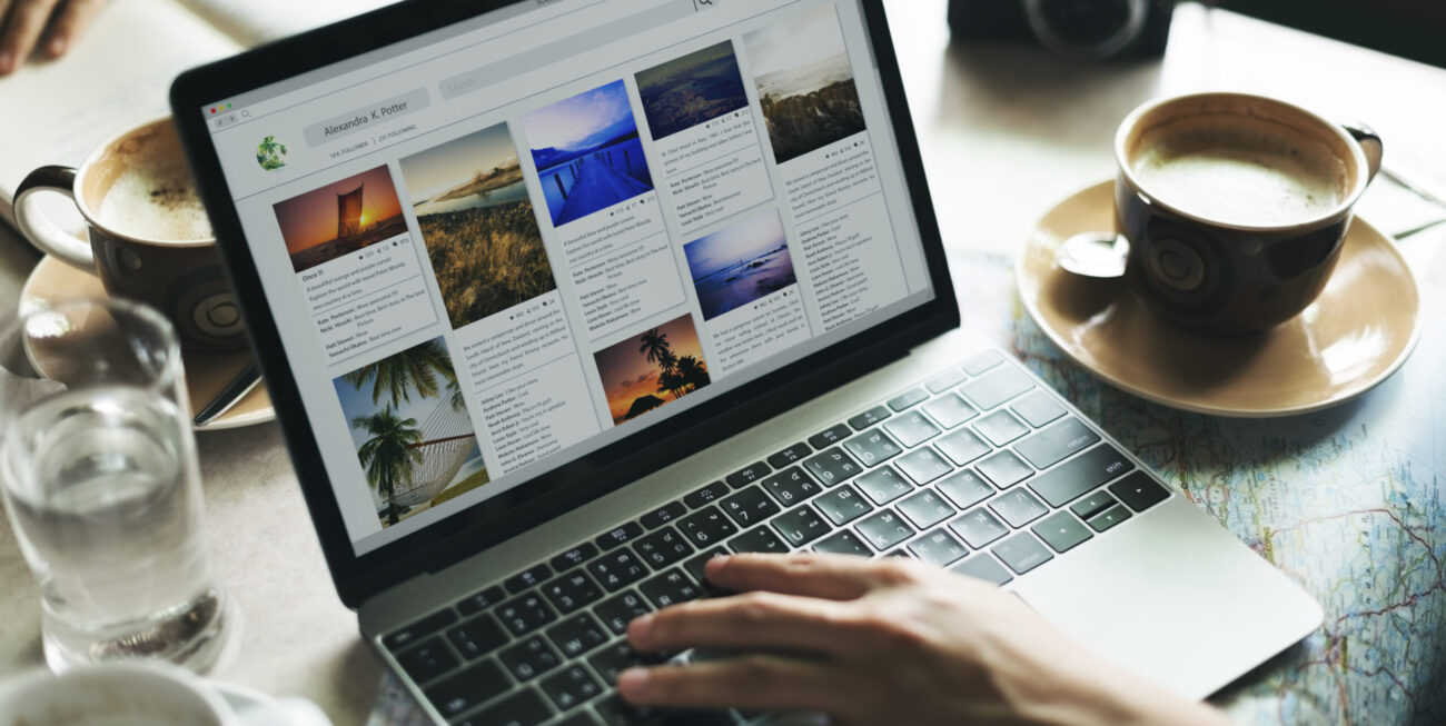 Person using laptop whose business is invisible online, with coffee nearby.