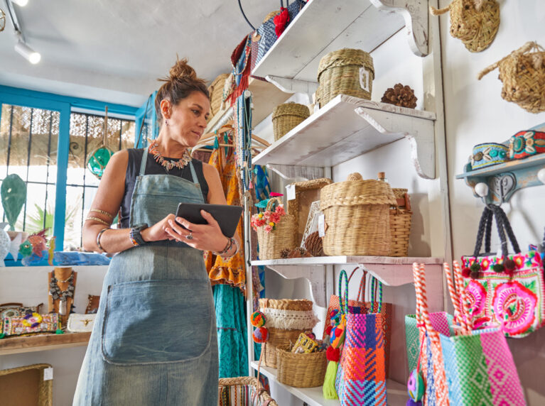 Woman updating her shop's Google Business Profile in store