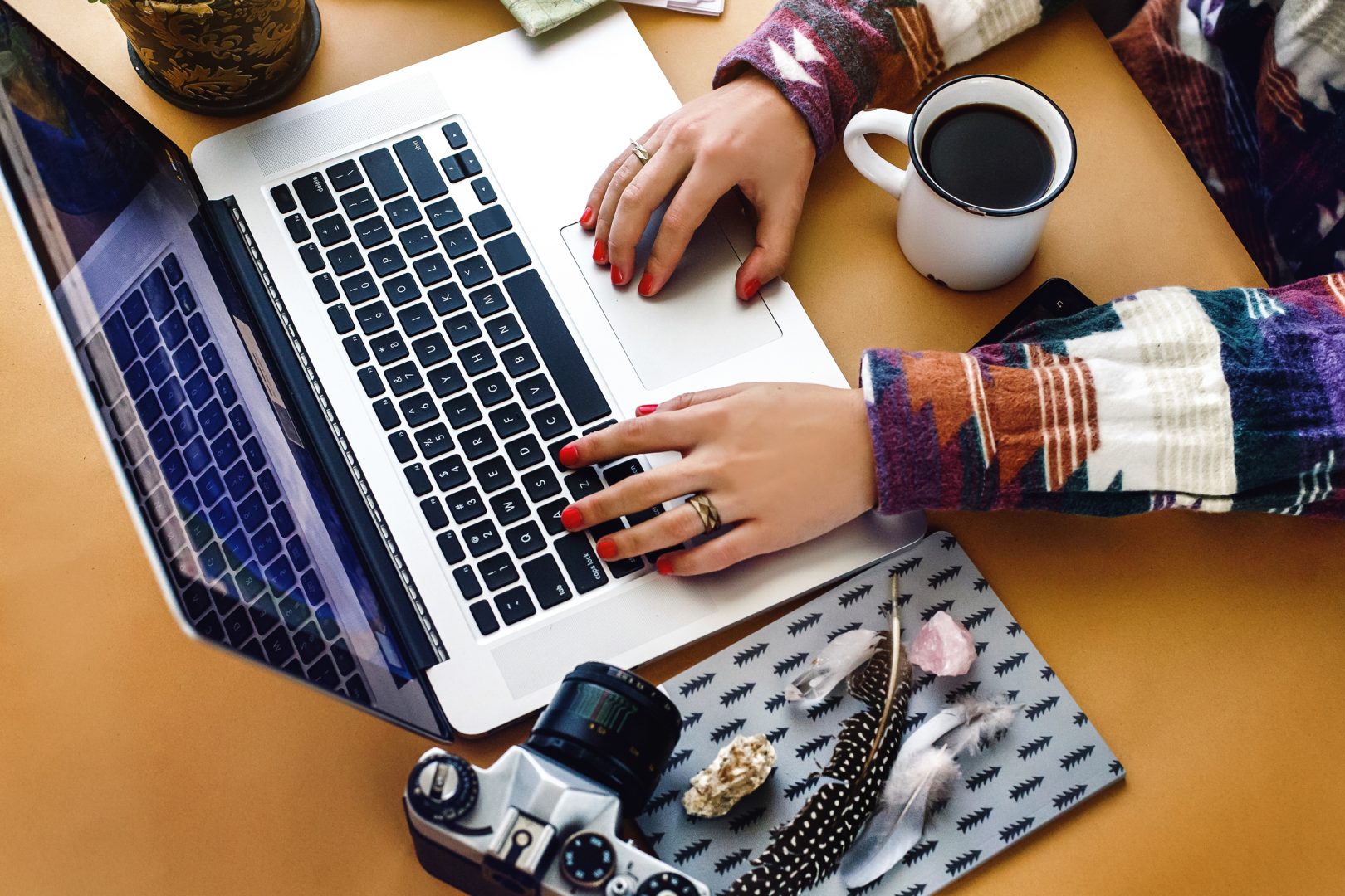 A person typing on a laptop, probably working on advertising in Surrey