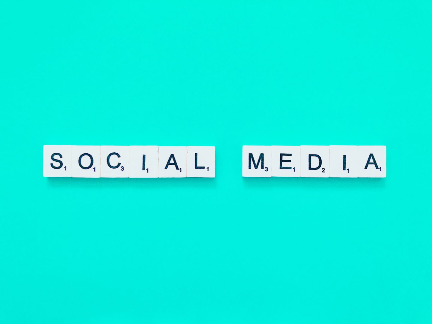 Scrabble letters spelling "social media"