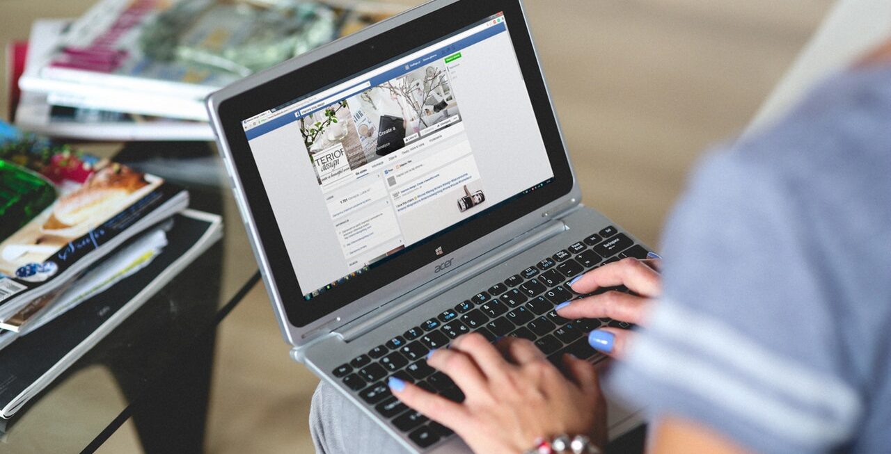 A woman leaving a Facebook comment that will need managing by a digital agency Surrey