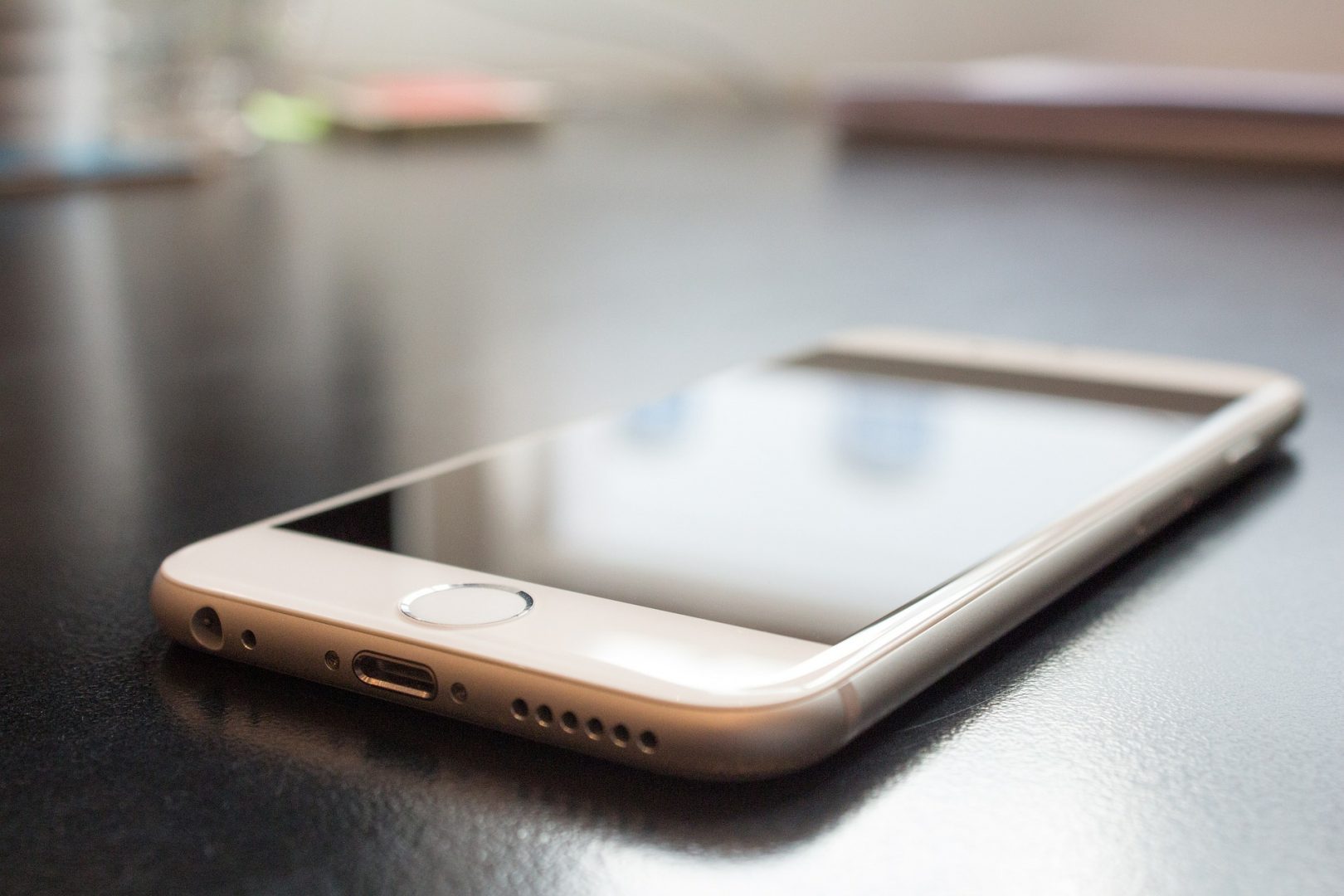 An iPhone lies on a table | Web Design Surrey