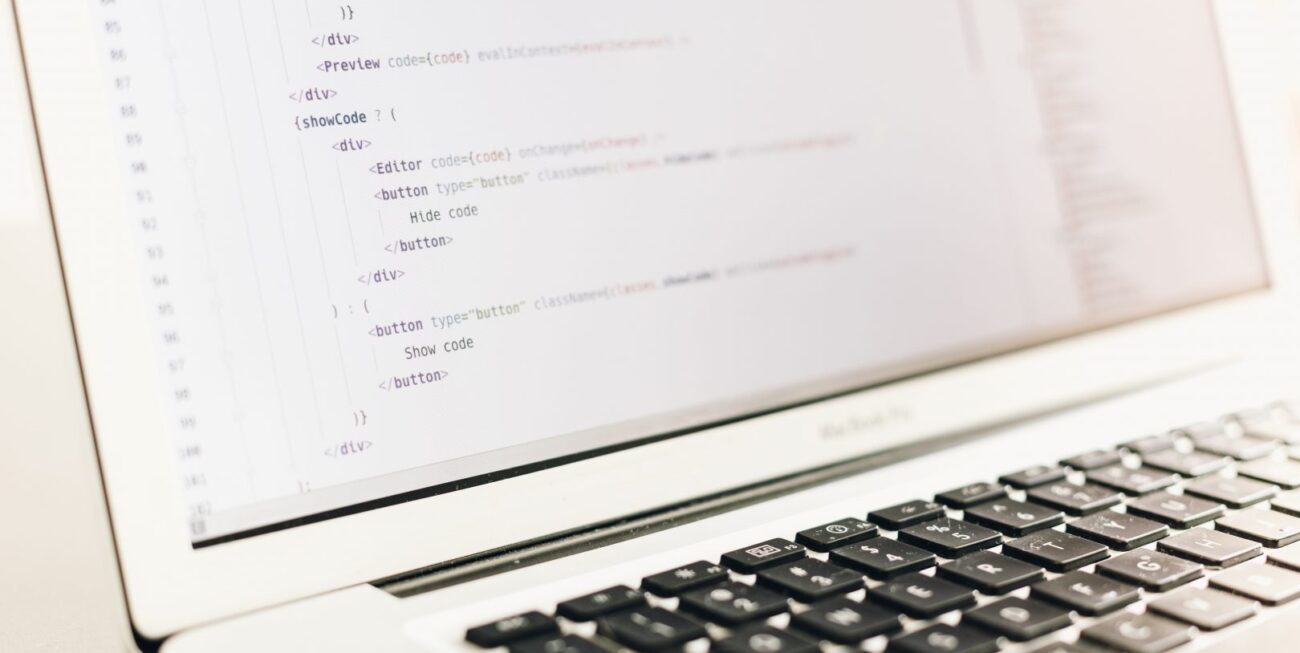 A laptop screen with website code, used for web design in Surrey projects.