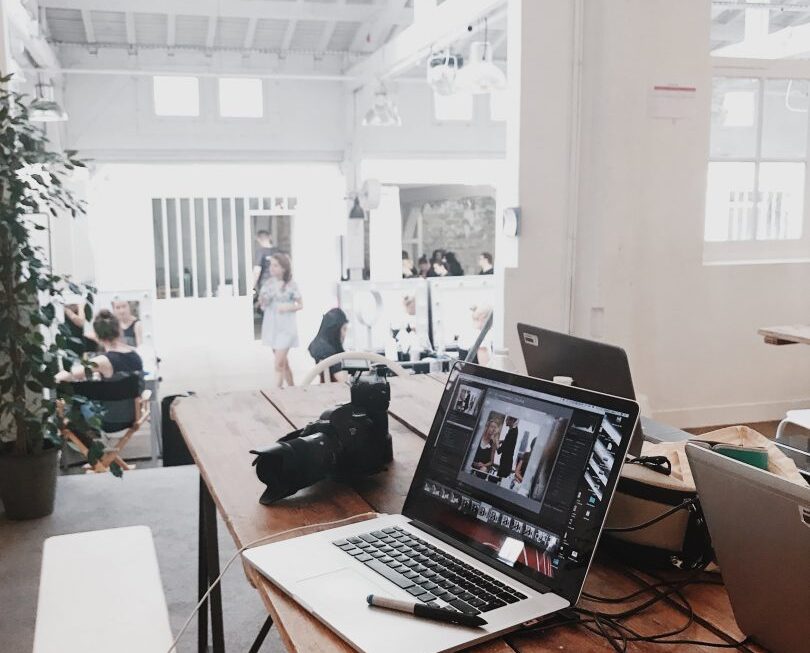 A laptop on top of a desk in an office.