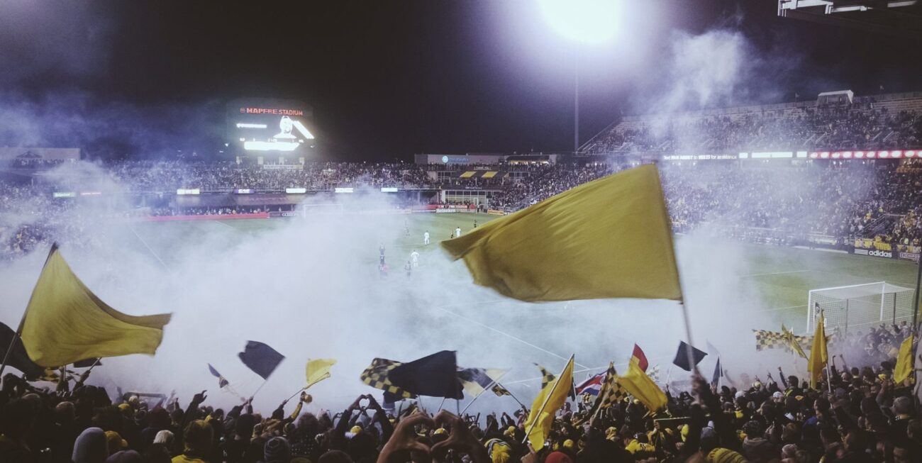 A crowd cheering on their football team near a digital marketing agency in Guildford.