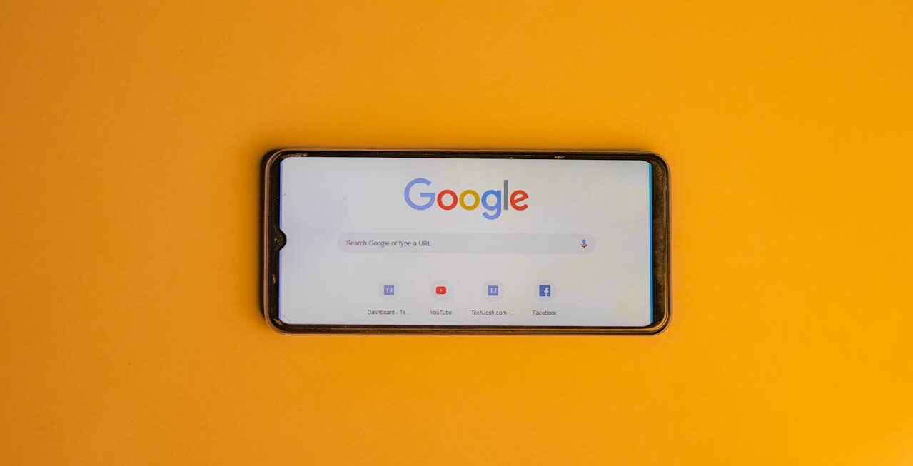 A phone showing Google on a yellow background | Surrey web design