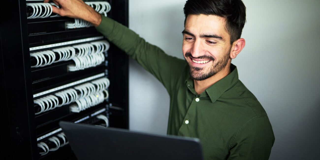 male technician in a server room for website hosting