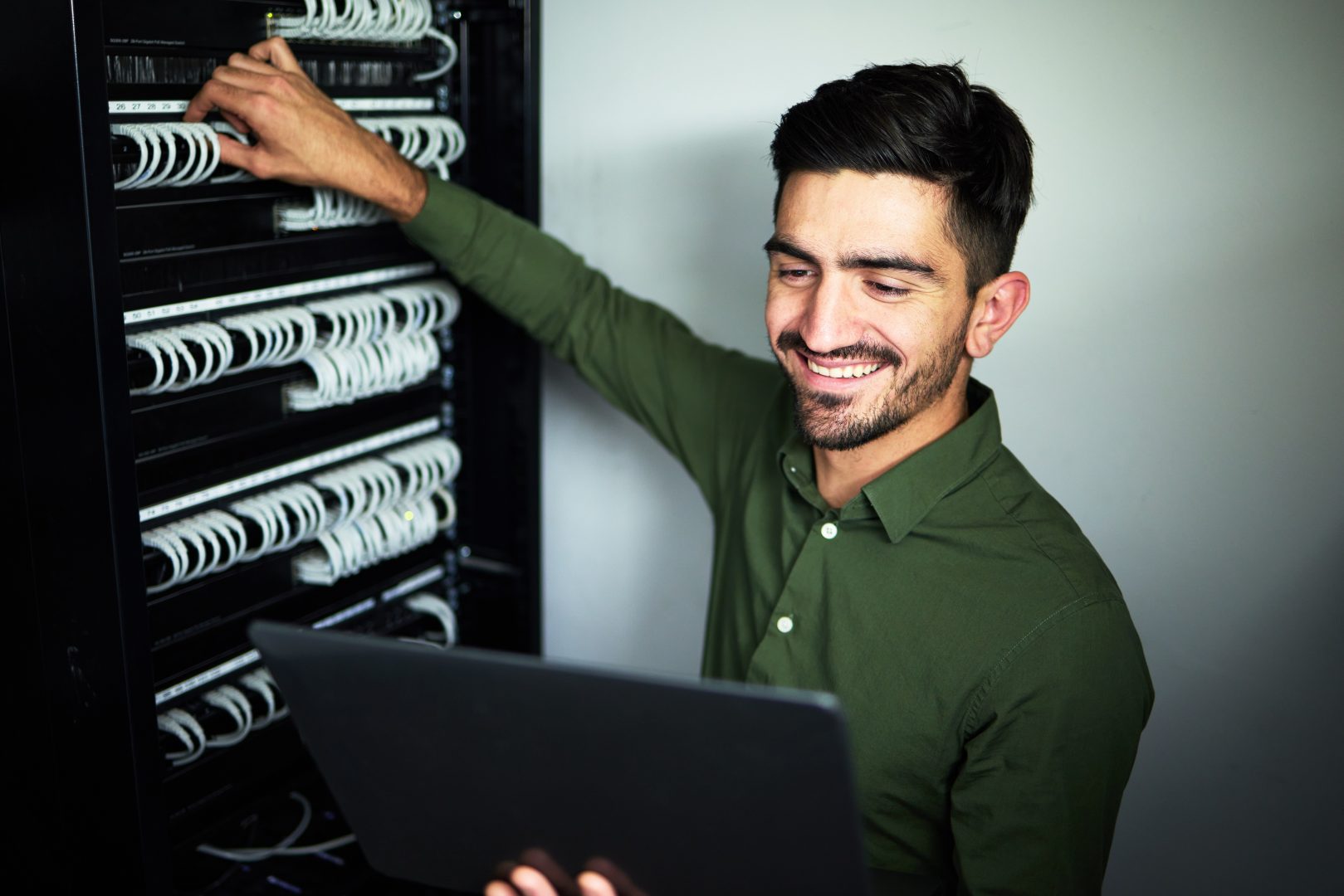 male technician in a server room for website hosting