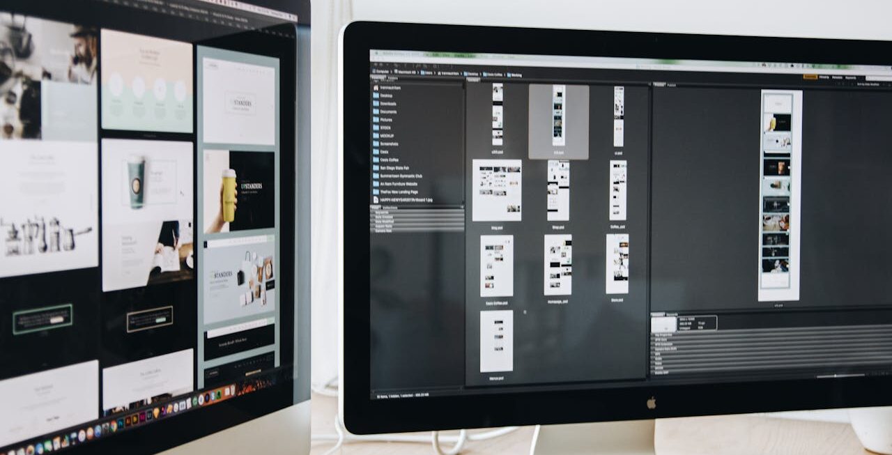 Two computer screens showing designs that might be on the desk of local website designers in Surrey