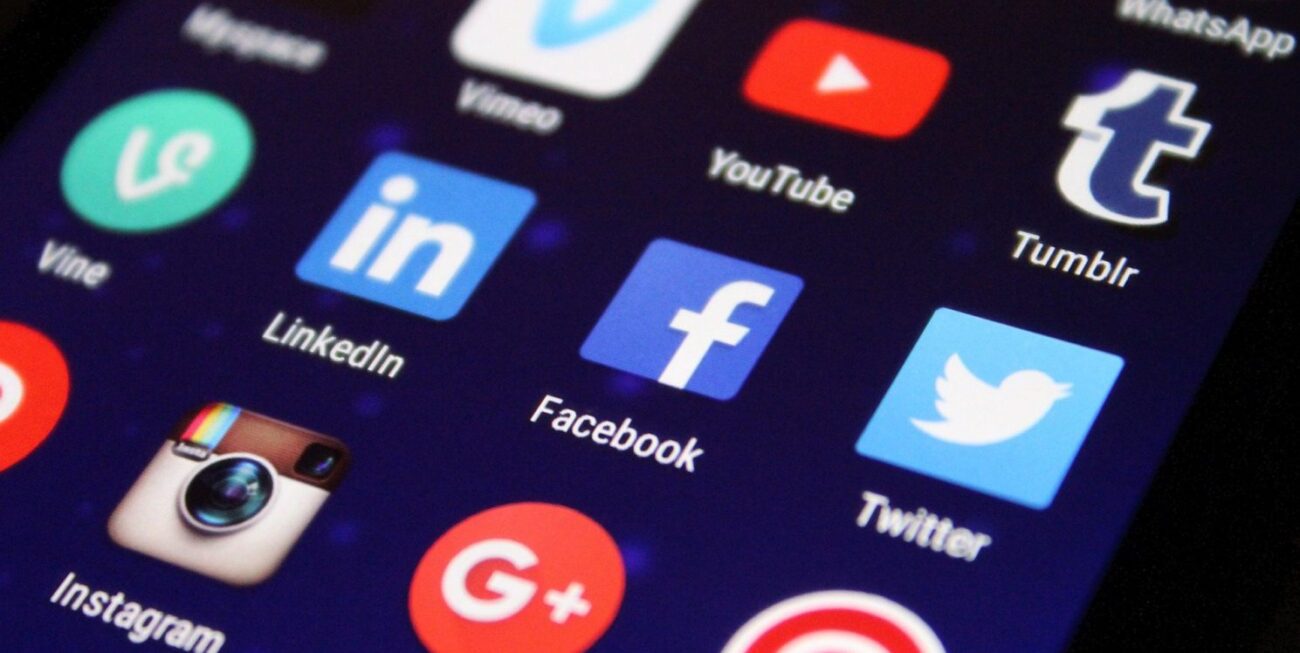 A photo of different social media apps on a phone screen, including Facebook, Instagram and Twitter.