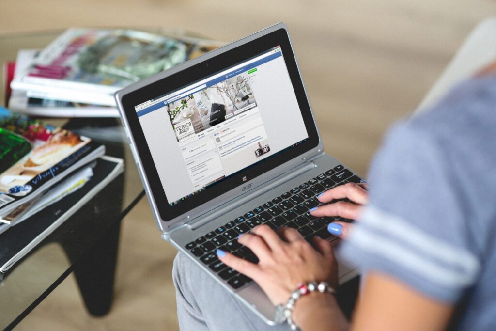 Person on a laptop looking at a Facebook page | Surrey marketing agency