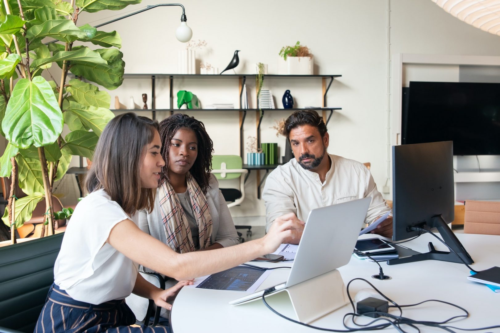 3 colleagues looking at a tablet screen
