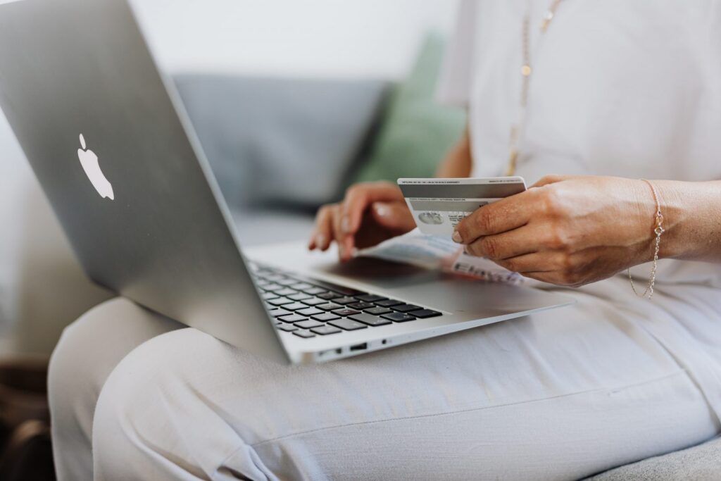 Someone filling out their credit card details on a laptop