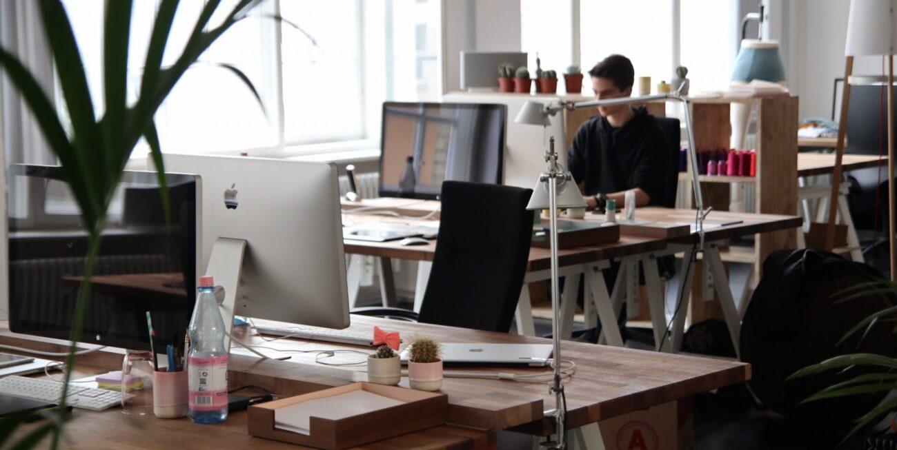 Several desks with a man working at one of them | Surrey web design