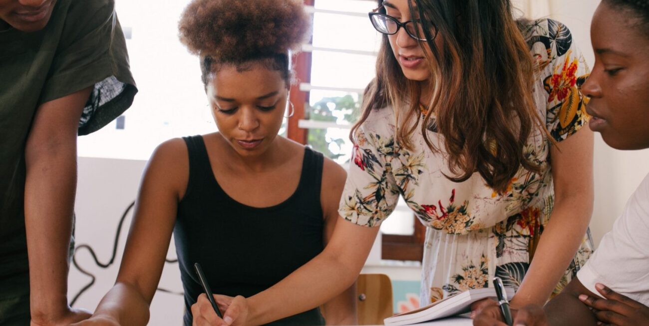A team brainstorming around a notebook