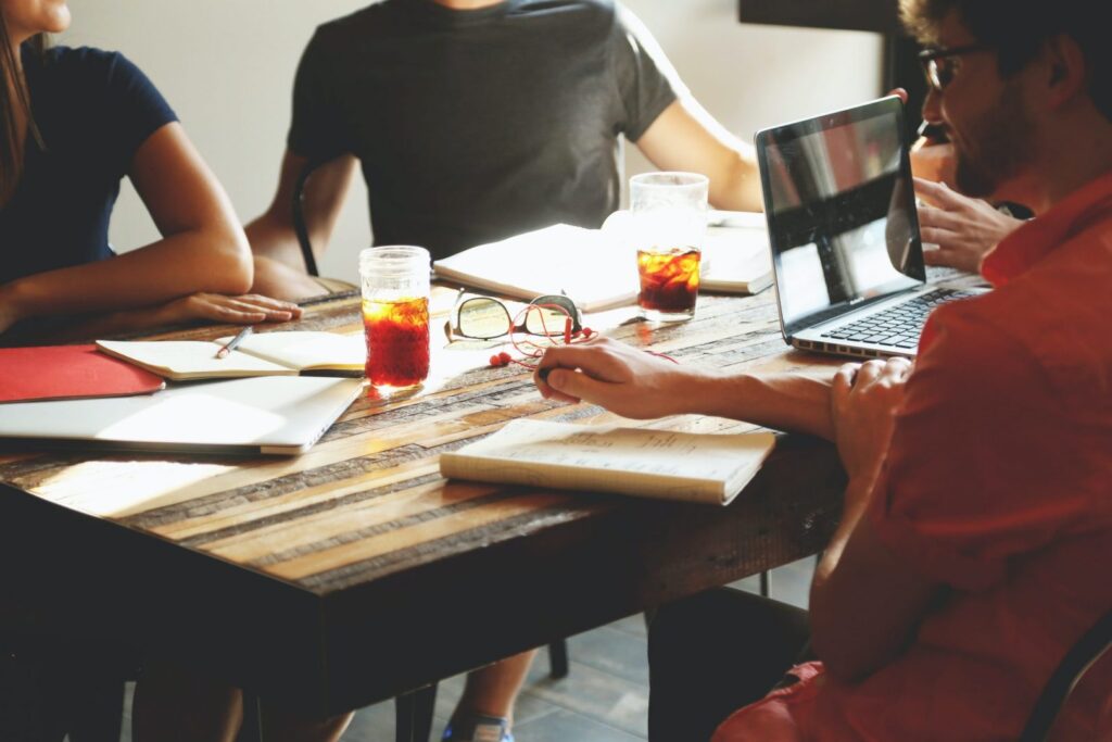 A relaxed team gathered around a table working together