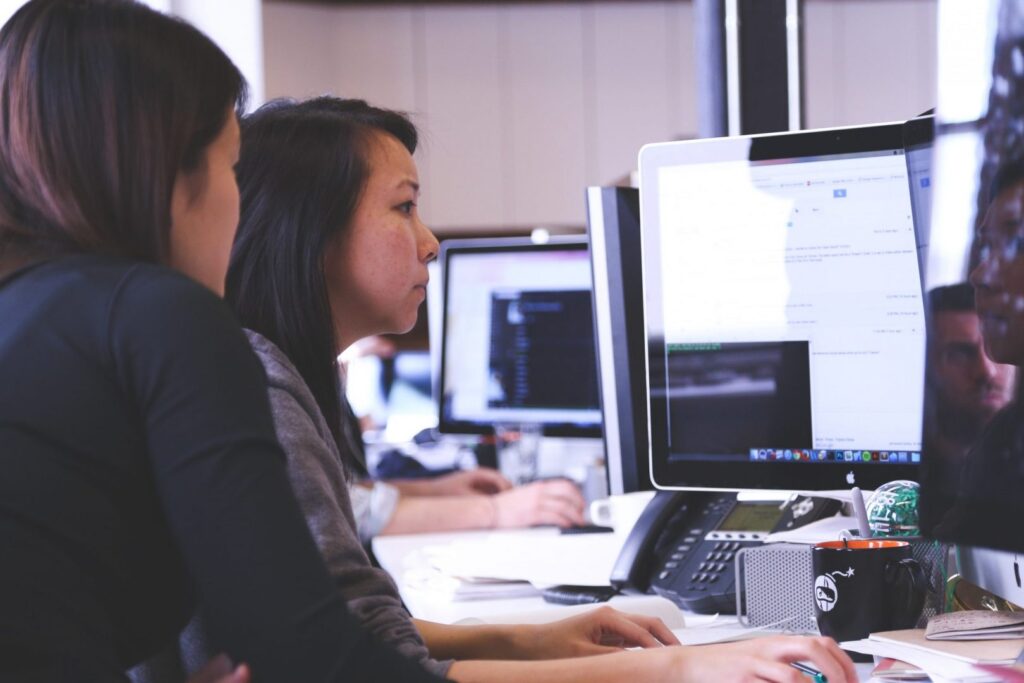 people looking at computer - Surrey web design
