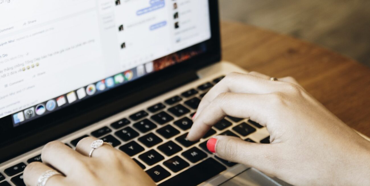 Someone typing in Facebook Messenger on a laptop