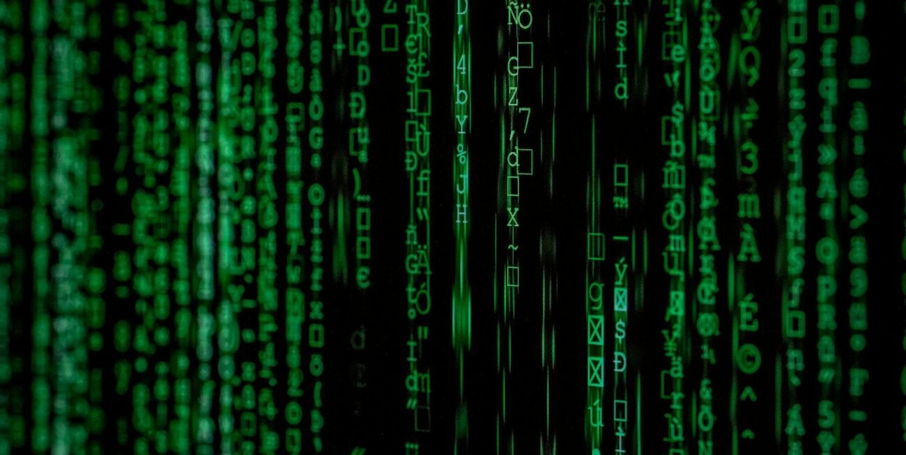 Green strings of text against a black background, representing social media algorithms that affect social media marketing