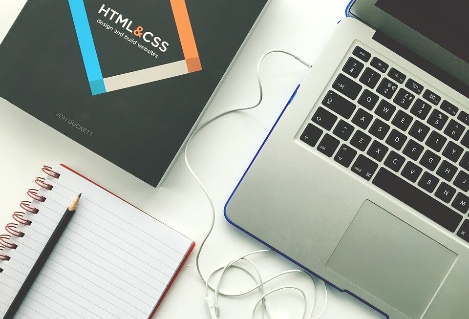 Important tools for creating beautiful Web development in Surrey: a laptop, notebook, & CSS/HTML guide