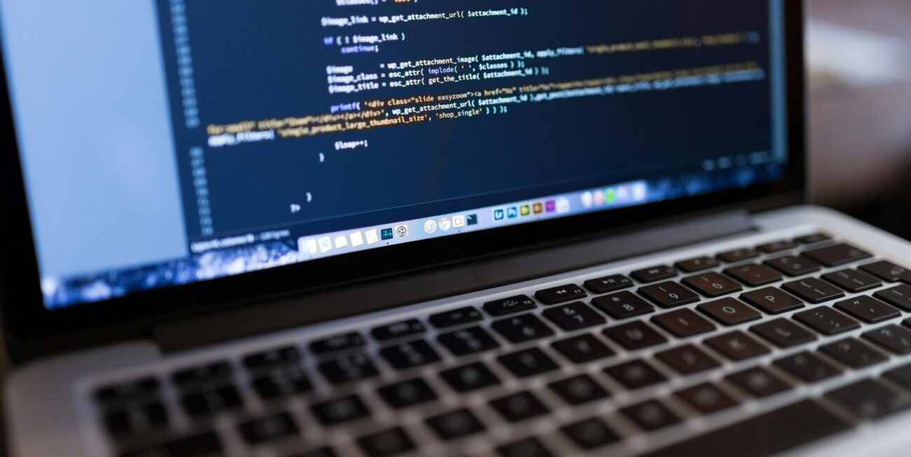 A laptop displaying code at a Surrey website development agency