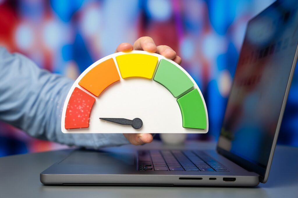 Laptop with a credit score speedometer in front, representing site speed