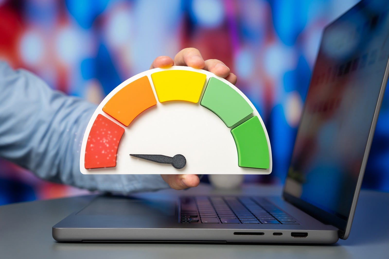 Laptop with a credit score speedometer in front, representing site speed